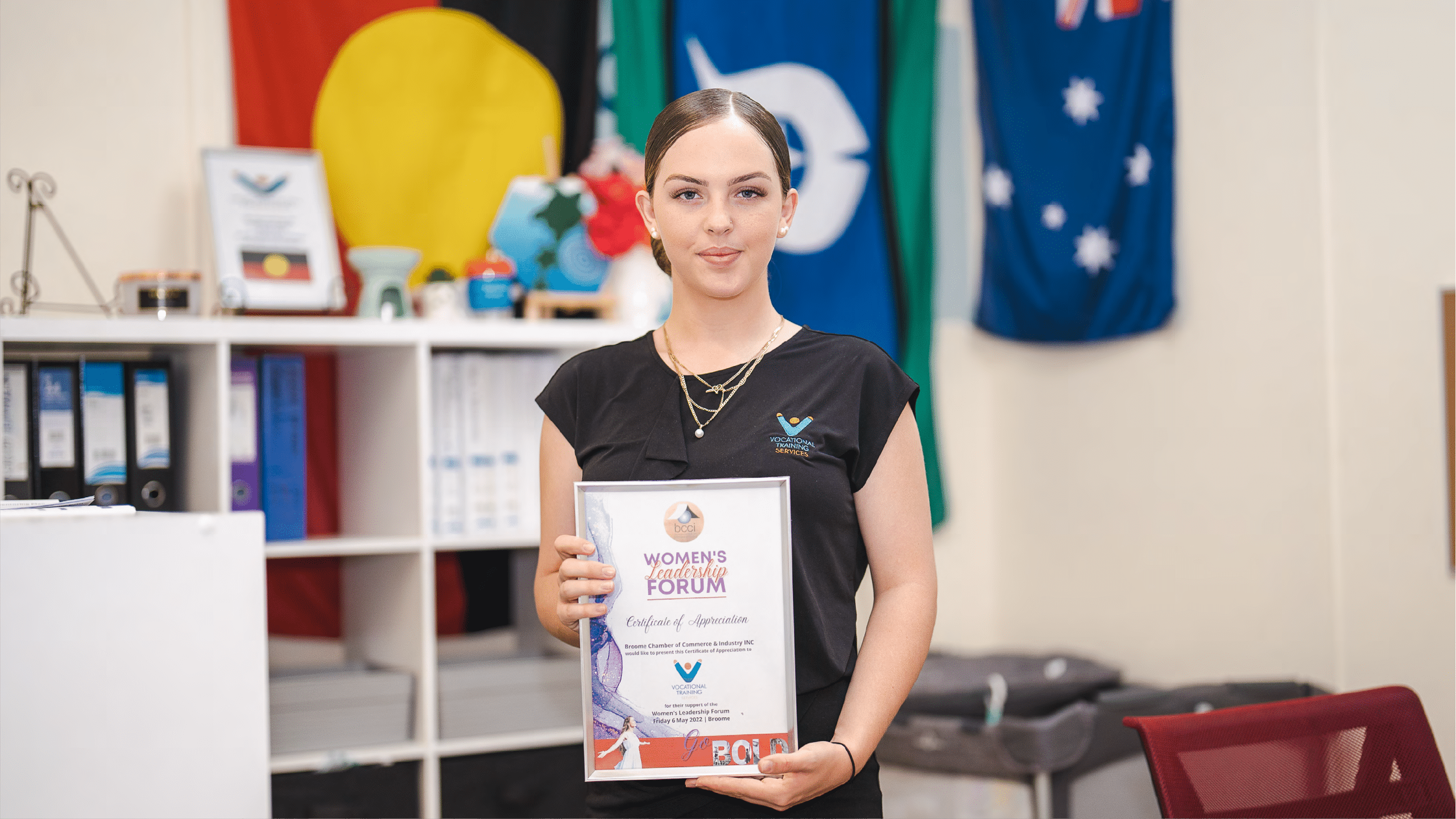 A student holding a certificate