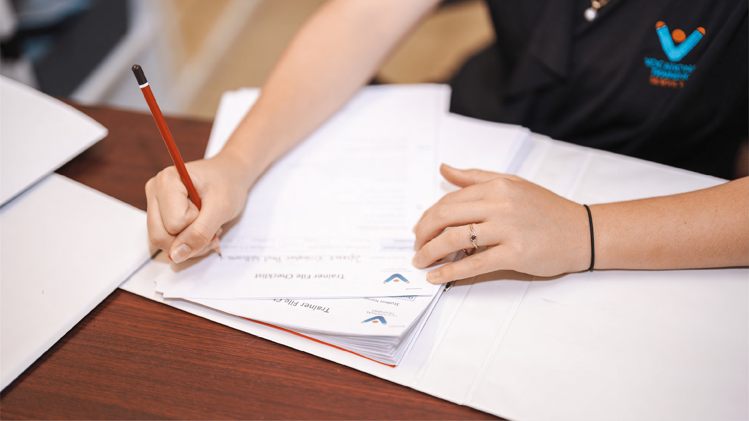 A student signing a document